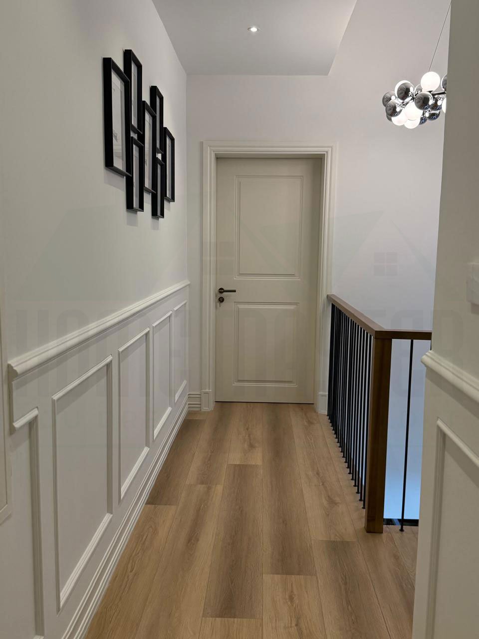 Marble stairs with a custom steel handrail design and feature wall
